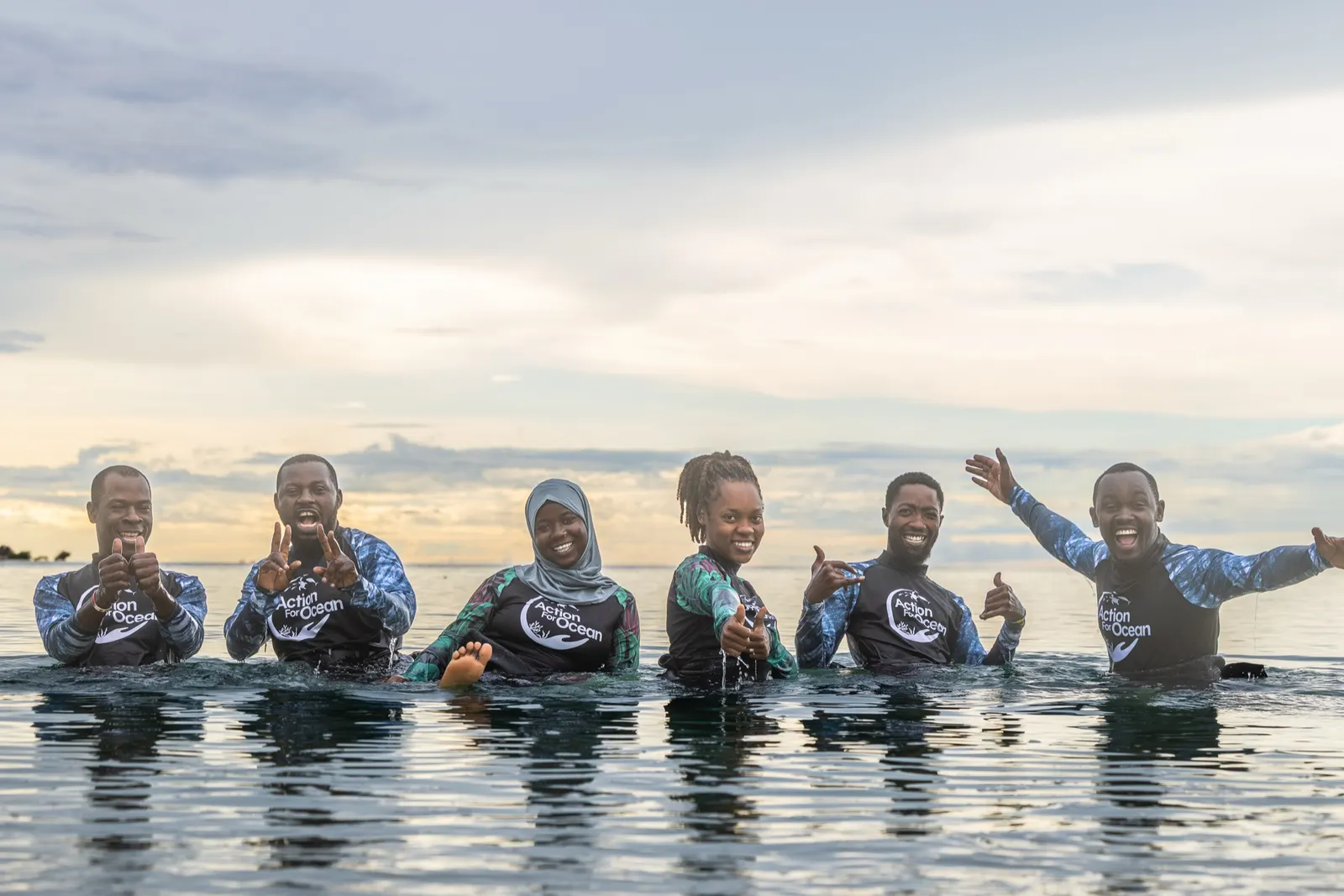Conservation team standing waist-deep in the sea